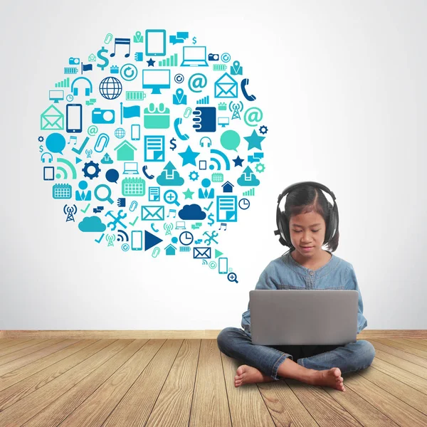 Little girl using laptop computer with application icons — Stock Photo, Image