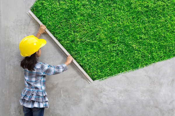 Kleines Mädchen Engineering-Ideen-Konzept mit Malerei grünen Gras Textur an der Wand Hintergrund — Stockfoto