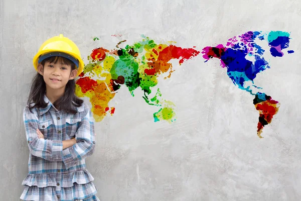 Little girl engineering with watercolor world map on wall — Stock Photo, Image