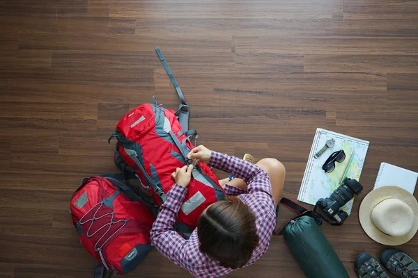 Overhead view of traveler woman plan and backpack planning — Stock Photo, Image
