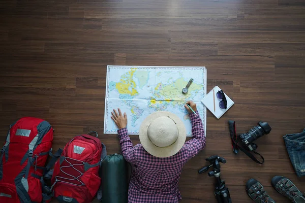 Overhead view of traveler woman plan and backpack planning