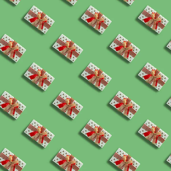 Seamless Christmas pattern with Xmas gift box on mint background.