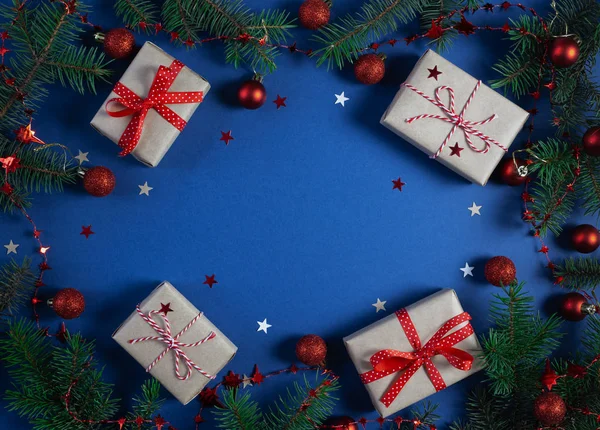 Christmas banner with gift boxes, Xmas tree, snowflakes and stars handmade on blue background with copy space.