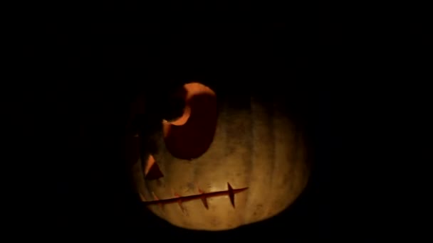 Pompoen Jack o'latern draait en verlicht in het donker — Stockvideo