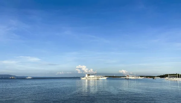 Monochrome beautiful landscape of blue sky and calm sea. Boats and ship drift in the ocean on the horizon. — Stock Photo, Image