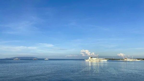 Monochrome beautiful landscape of blue sky,calm sea.Boats drift in ocean.Sun day