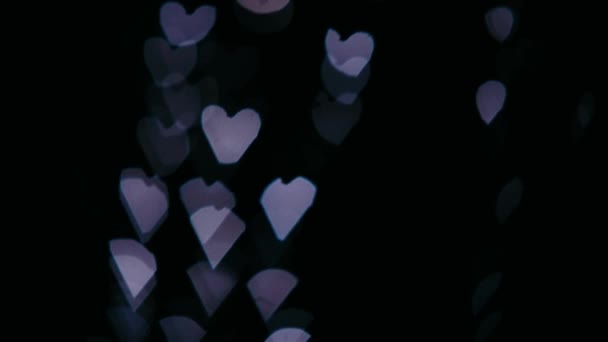 Fond Saint-Valentin, Boucle volant abstraits cœurs colorés et particules isolé fond noir avec clip alpha. Pour concevoir des cartes de vœux et des bannières animées .