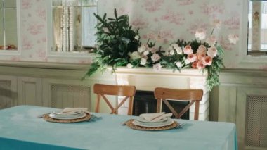 winter decor of a wedding banquet hall with blue tablecloths and beautiful soft pink flowers