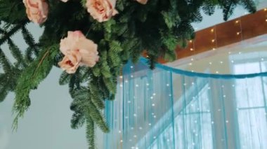 winter decor of a wedding banquet hall with blue tablecloths and beautiful soft pink flowers
