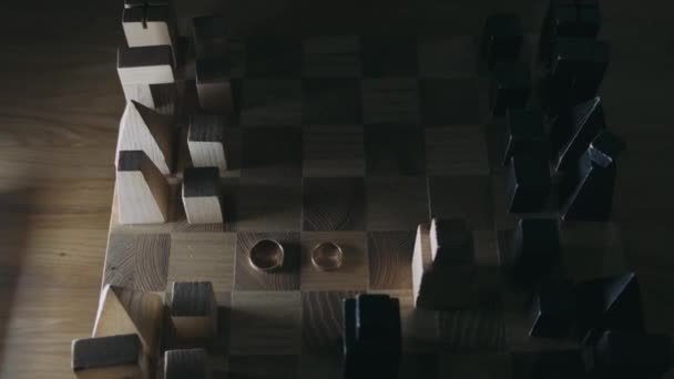 Wedding Rings Lie Chessboard Light Falls Them — Stock Video