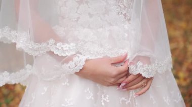 Kız dantelli gelinliği okşuyor