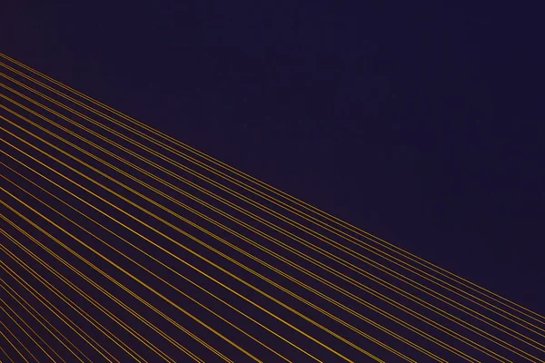 Mordern cable stayed bridge with illuminated cables. Abstract detail photo.