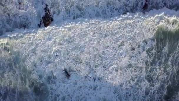 Aerial view on huge waves at sunset. Big ocean waves break with white sea foam — Stock Video