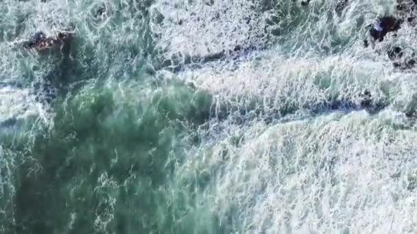 Top down view on huge and powerful waves cover rocky coast of the Atlantic Ocean — Stock Video