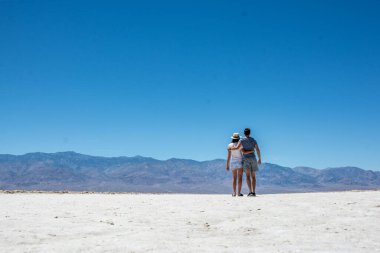 Arizona çölündeki tuzlu göl çölünde yürüyen çift. güneşli, mavi gökyüzü