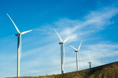 Palm Springs, California, Amerika Birleşik Devletleri 'nde mavi gökyüzüne karşı yel değirmeni çiftliği