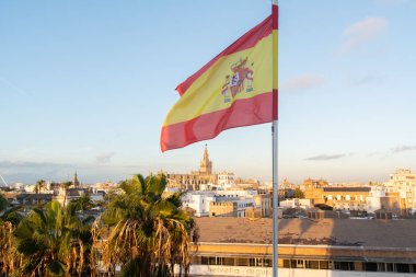 Torre del Oro 'nun üstünde sallanan İspanya bayrağı ve şehrin çarpıcı panoramik manzarası.