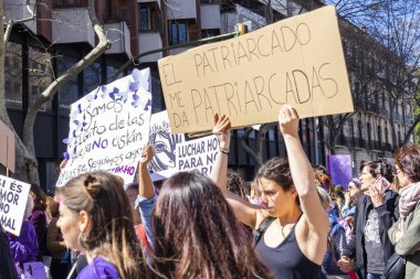 Palma de Mallorca, Spain - March 08, 2020: International Women's Day. Girl in front of the demonstration holding a banner against patriarchy.