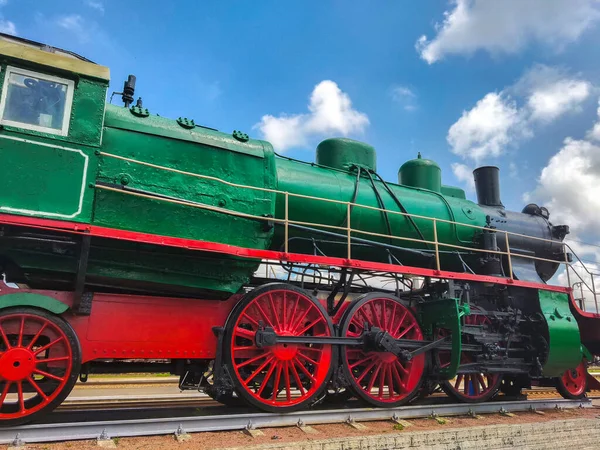 vintage green train locomotive at the station