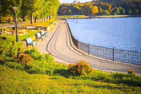 City embankment near the lake with equipped infrastructure for recreation.