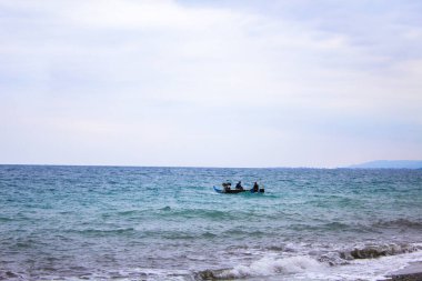 Fishing boat with trolling equipment, rod, line, reel. Beautiful ocean sunset. fishing boat on the blue water and blue sky. 