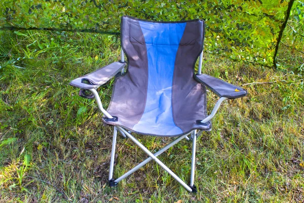 empty camping chair in nature background. Colorful chair and summer camping day.