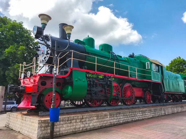 vintage green train locomotive at the station