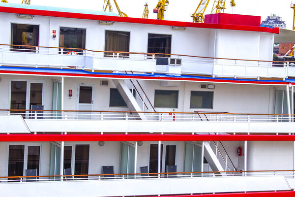 Closeup view of a huge cruise ship. Balconies and chairs. a series of hundreds of rooms on a cruise ship