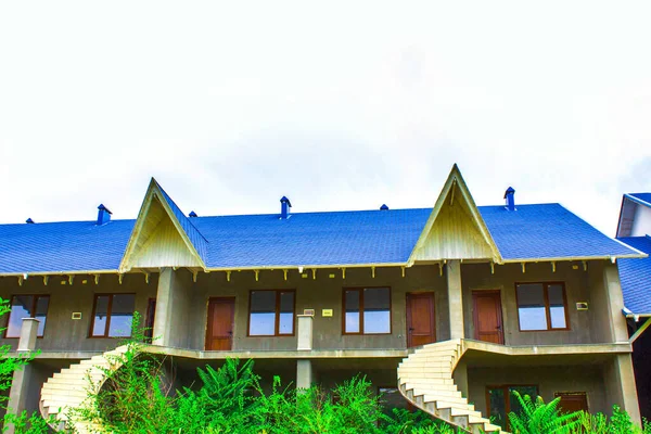 blue roof country house with stairs