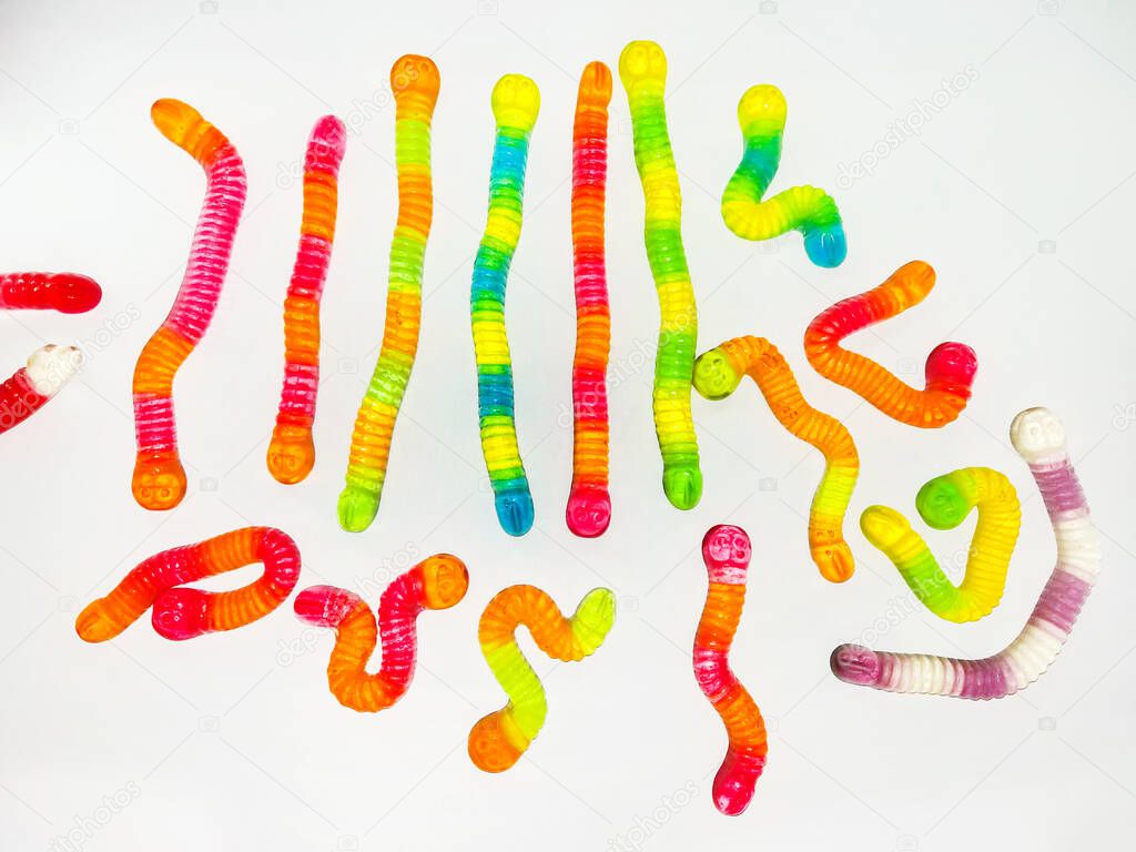 Multicolored jelly, sweets in shape of worm . Top view. Sweet background