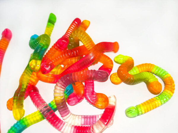 Multicolored jelly, sweets in shape of worm . Top view. Sweet background