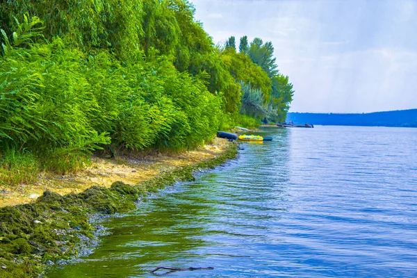 landscape with Dniester river smooth water surface and hill land horizon background in clear summer weather time