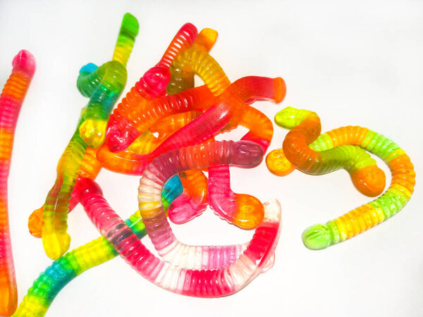Multicolored jelly, sweets in shape of worm . Top view. Sweet background