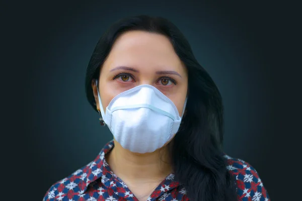 Portrait of young female. European woman wearing a face mask,  isolated on color background.