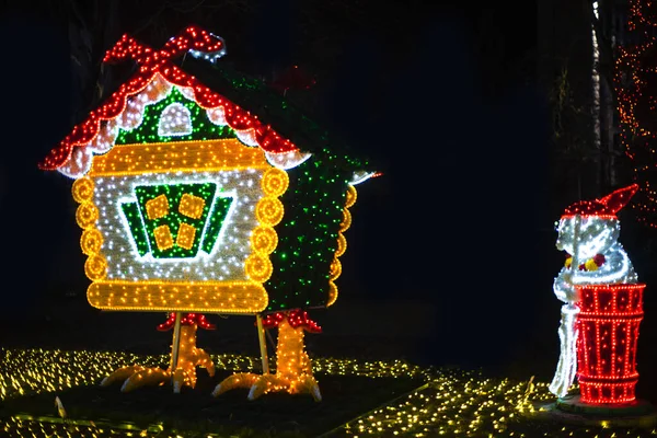 a hut on chicken legs, glowing trees, figures on a city park