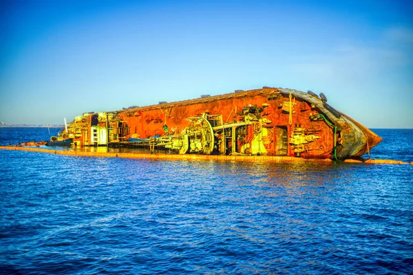 Closeup sunken tanker. Ship through after storm ashore. The tanker lies on its side.