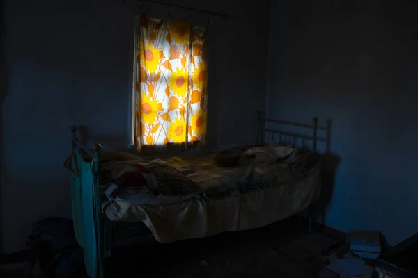 old dark bedroom interior with rustic bed