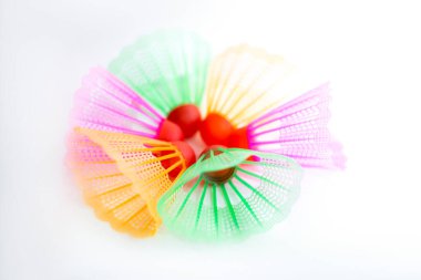 Çok renkli badminton toplarını beyaz arka plana yerleştir. Düz yatıyordu. Minimalizm. Spor, fitness, sağlıklı yaşam tarzı ve nesneler konsepti