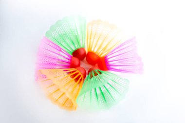 Çok renkli badminton toplarını beyaz arka plana yerleştir. Düz yatıyordu. Minimalizm. Spor, fitness, sağlıklı yaşam tarzı ve nesneler konsepti