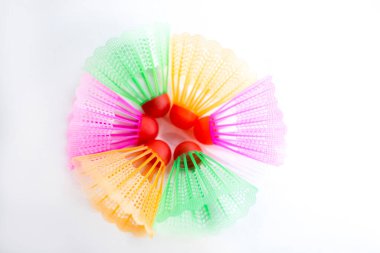 Çok renkli badminton toplarını beyaz arka plana yerleştir. Düz yatıyordu. Minimalizm. Spor, fitness, sağlıklı yaşam tarzı ve nesneler konsepti