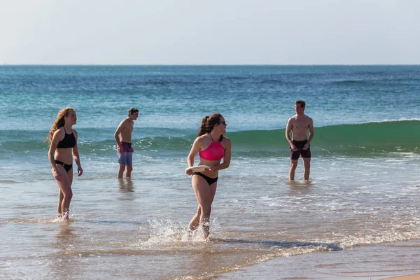 Adolescentes playa frisbee lanzar — Foto de Stock
