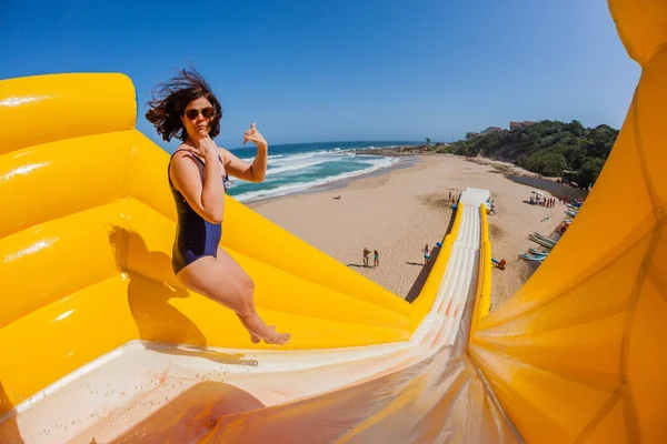 Spiaggia ragazza salto eccitazione alto scivolo d'acqua — Foto Stock