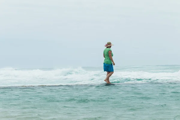 Mannen tidvatten Pool vägg titta på havet — Stockfoto