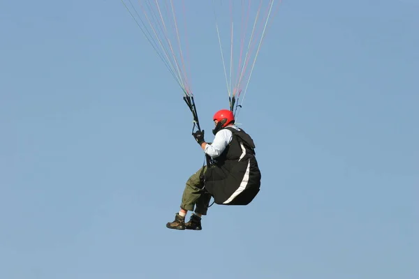 man in jump with parachute on the sky