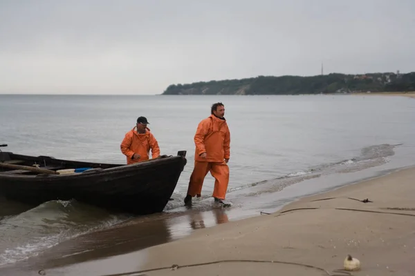two fishermen arrived in the early morning on the beach