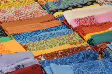 colorful textile fabrics in a store clipart