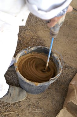 grinding clay pot with a brush clipart