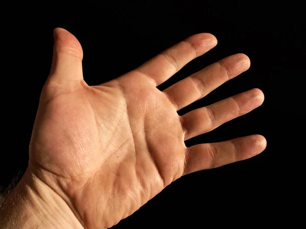 Hand Met Een Bord Een Zwarte Achtergrond — Stockfoto