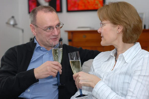 middle-aged couple with champagne glasses