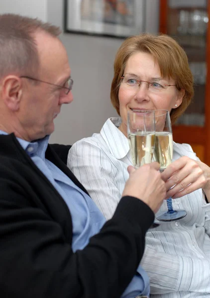middle aged couple with champagne glasses
